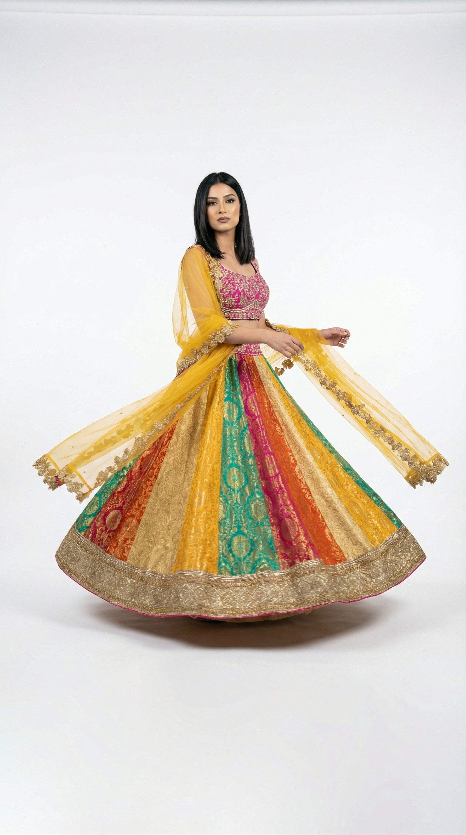 Detail shot of the hot pink sleeveless blouse featuring dense gold embroidery, paired with the multicolor skirt.