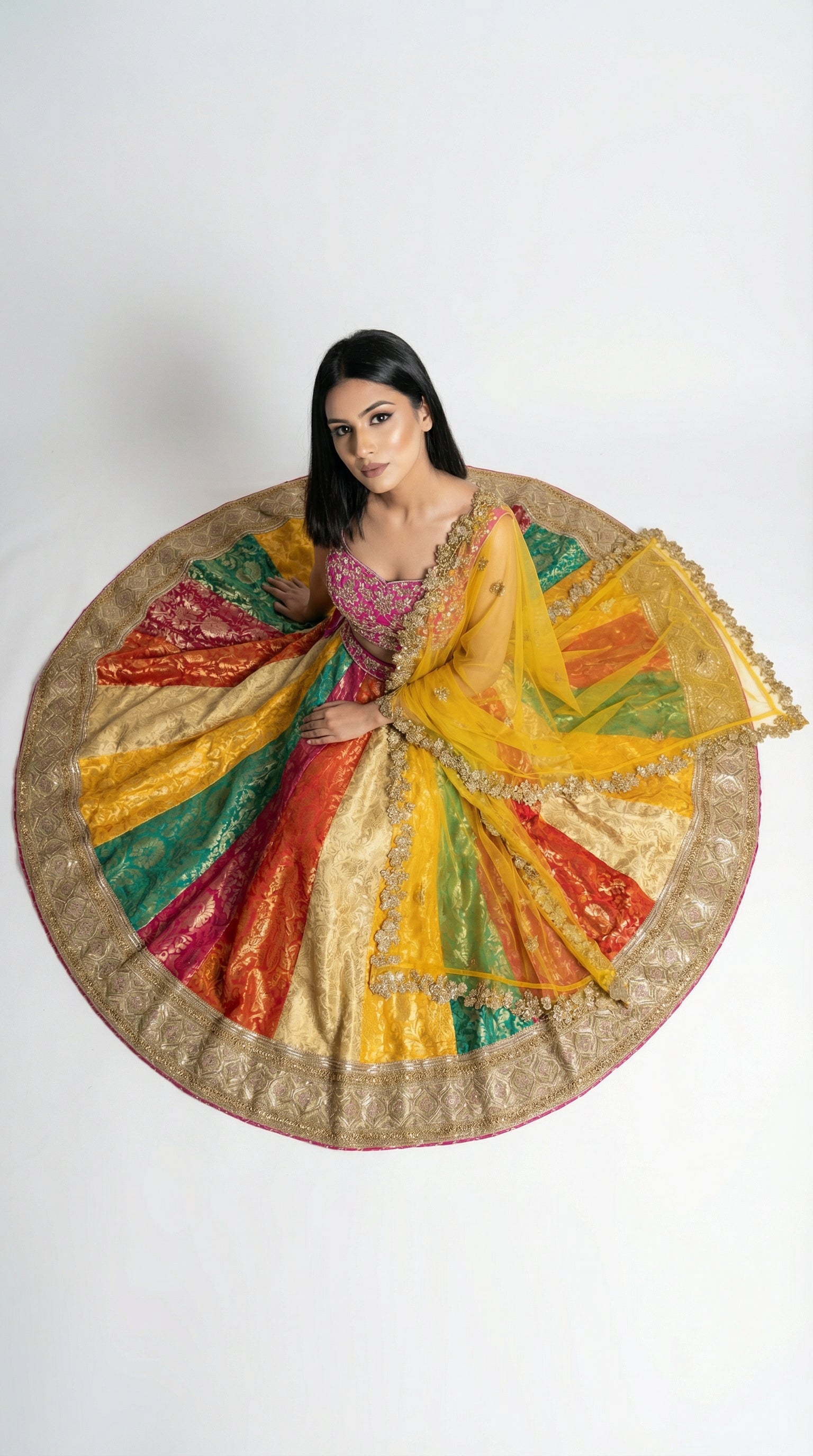 Close-up detail of the multi-colored panels on the banarasi skirt showing the intricate gold woven zari motifs.