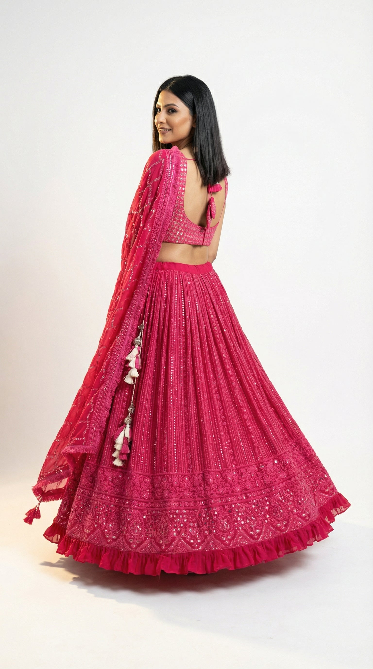 Detail shot of the matching sleeveless pink blouse adorned with heavy mirror work and thread embroidery.