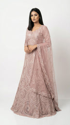 A stylish pose showing the flare and elegance of the monochromatic pink sequin lehenga, perfect for an engagement party.