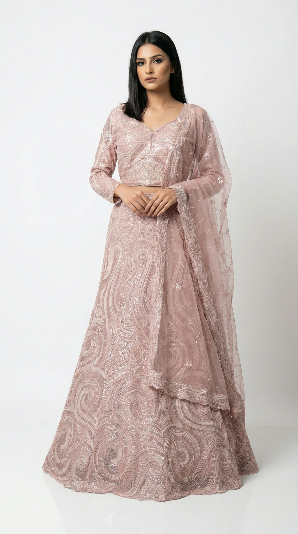 Full body front view of the Rosio House dusty pink lehenga featuring a modern swirl sequin pattern and full-sleeve blouse.