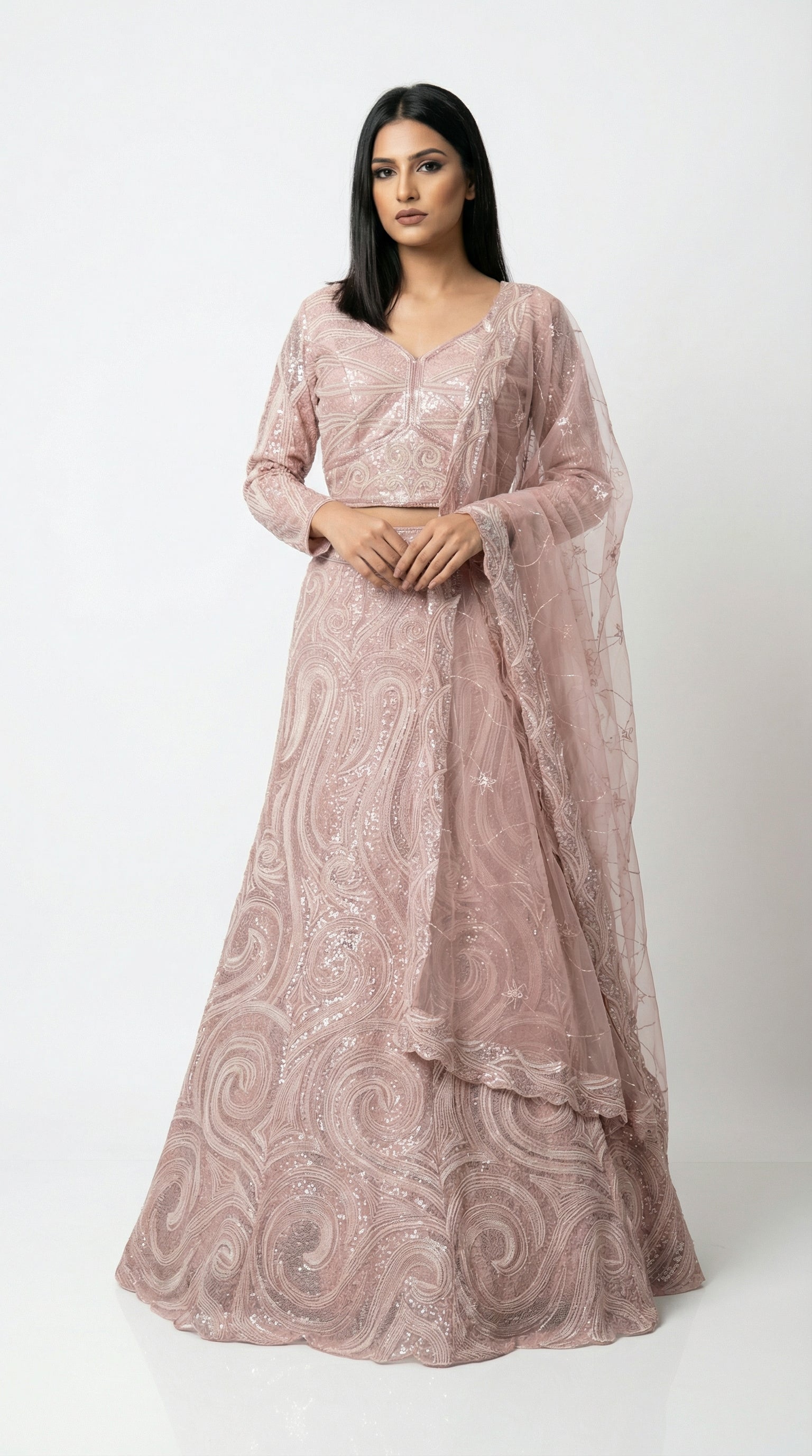 Full body front view of the Rosio House dusty pink lehenga featuring a modern swirl sequin pattern and full-sleeve blouse.