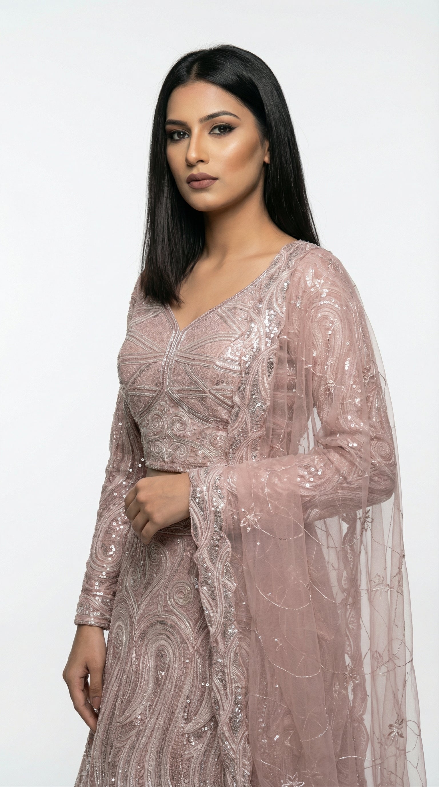 Close-up detail of the intricate thread and sequin wave pattern on the blush pink lehenga skirt.