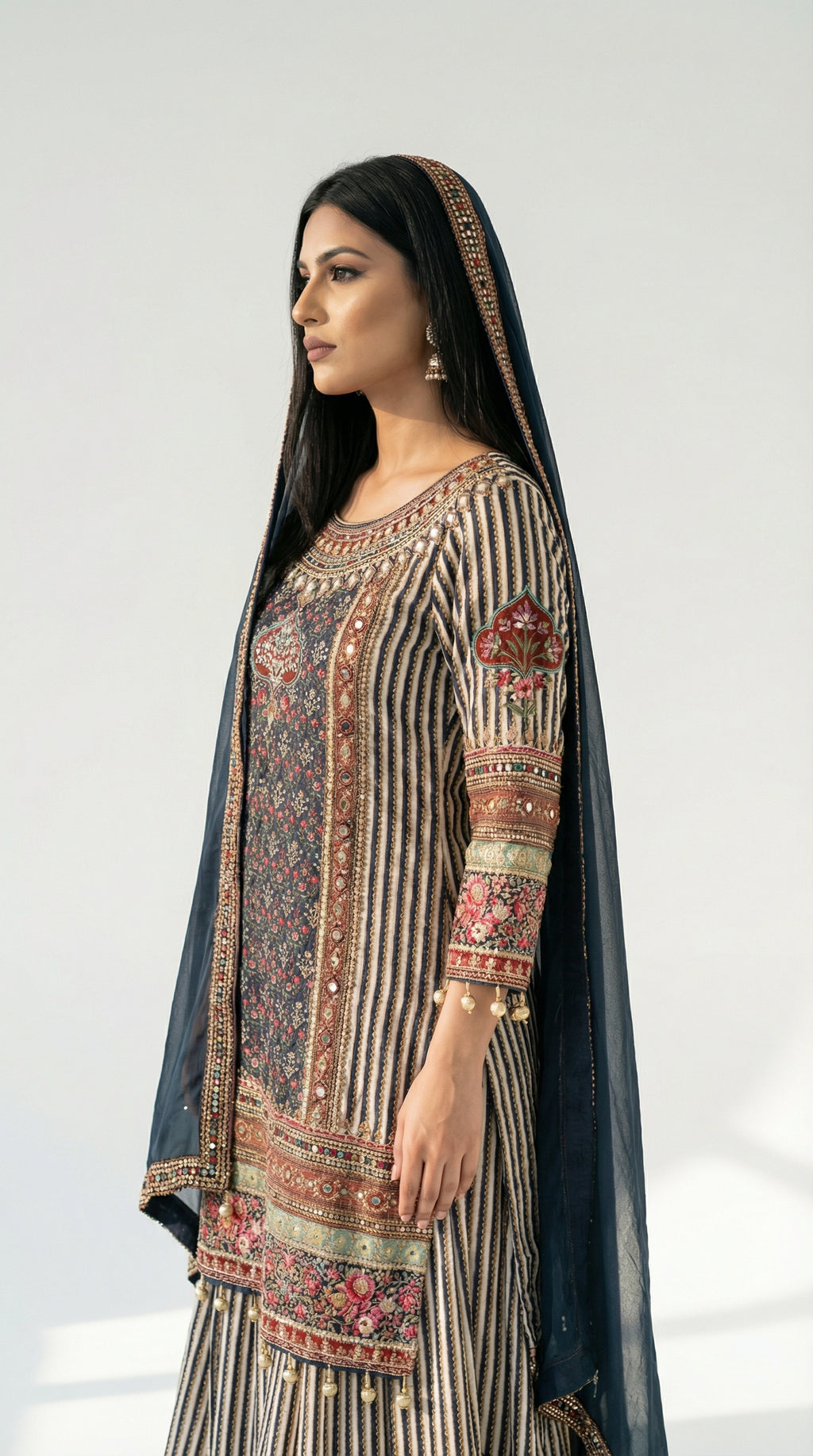 A view of the solid navy blue dupatta draped over the shoulder, contrasting with the busy print of the kurta's bodice and sleeves.