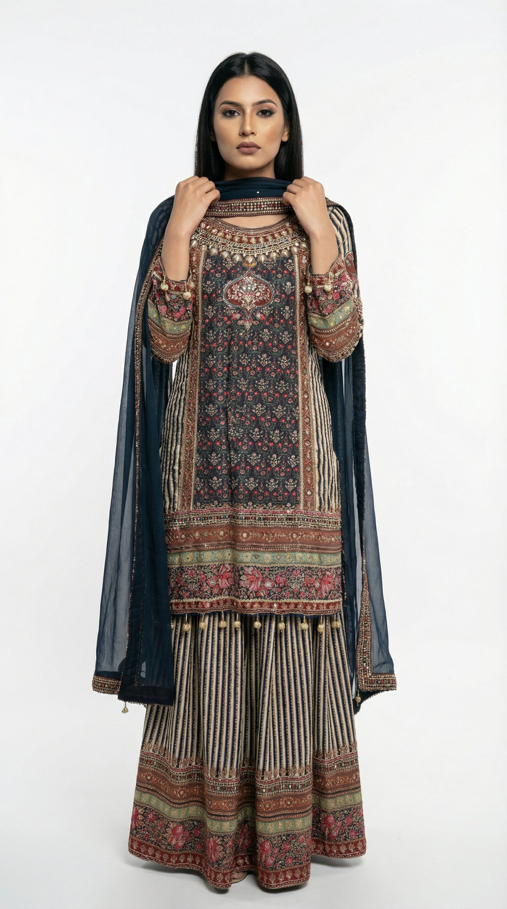 Detail shot of the wide-leg sharara pants showing the vertical striped pattern and heavy printed border at the bottom.