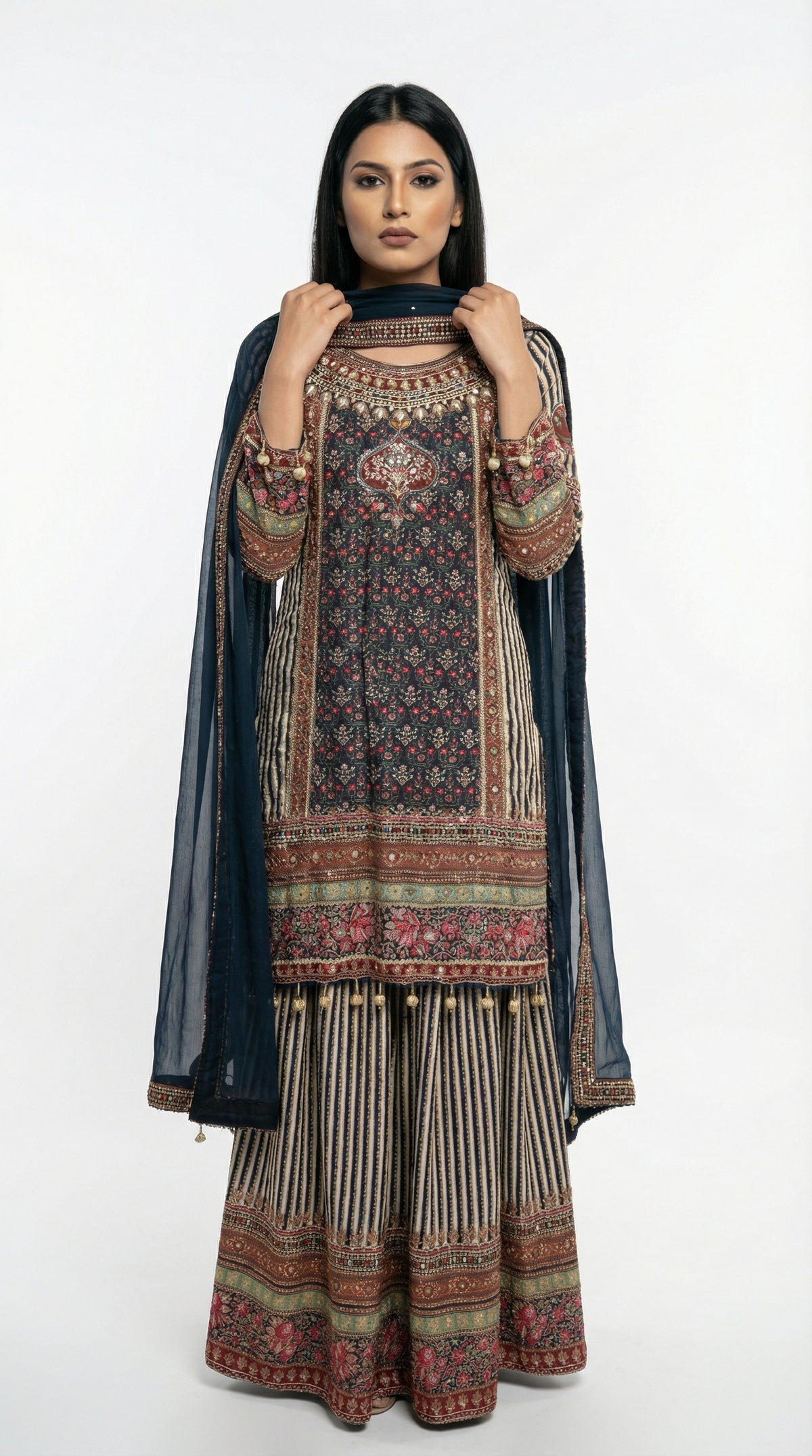 Detail shot of the wide-leg sharara pants showing the vertical striped pattern and heavy printed border at the bottom.
