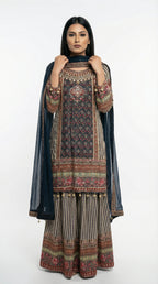 Detail shot of the wide-leg sharara pants showing the vertical striped pattern and heavy printed border at the bottom.