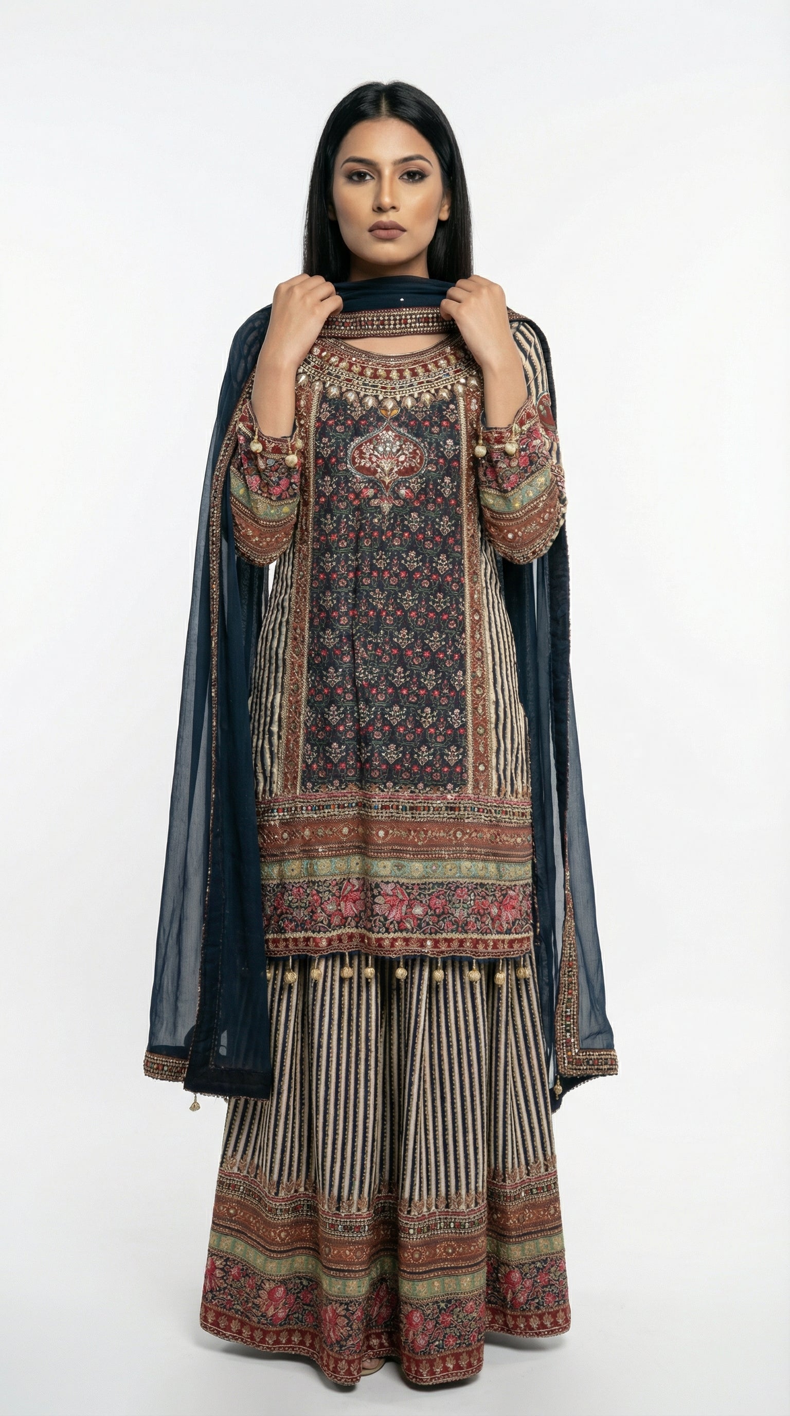 Detail shot of the wide-leg sharara pants showing the vertical striped pattern and heavy printed border at the bottom.