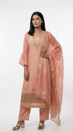 A stylish pose showing the complete pastel peach suit look, perfect for a sophisticated day event or office celebration.