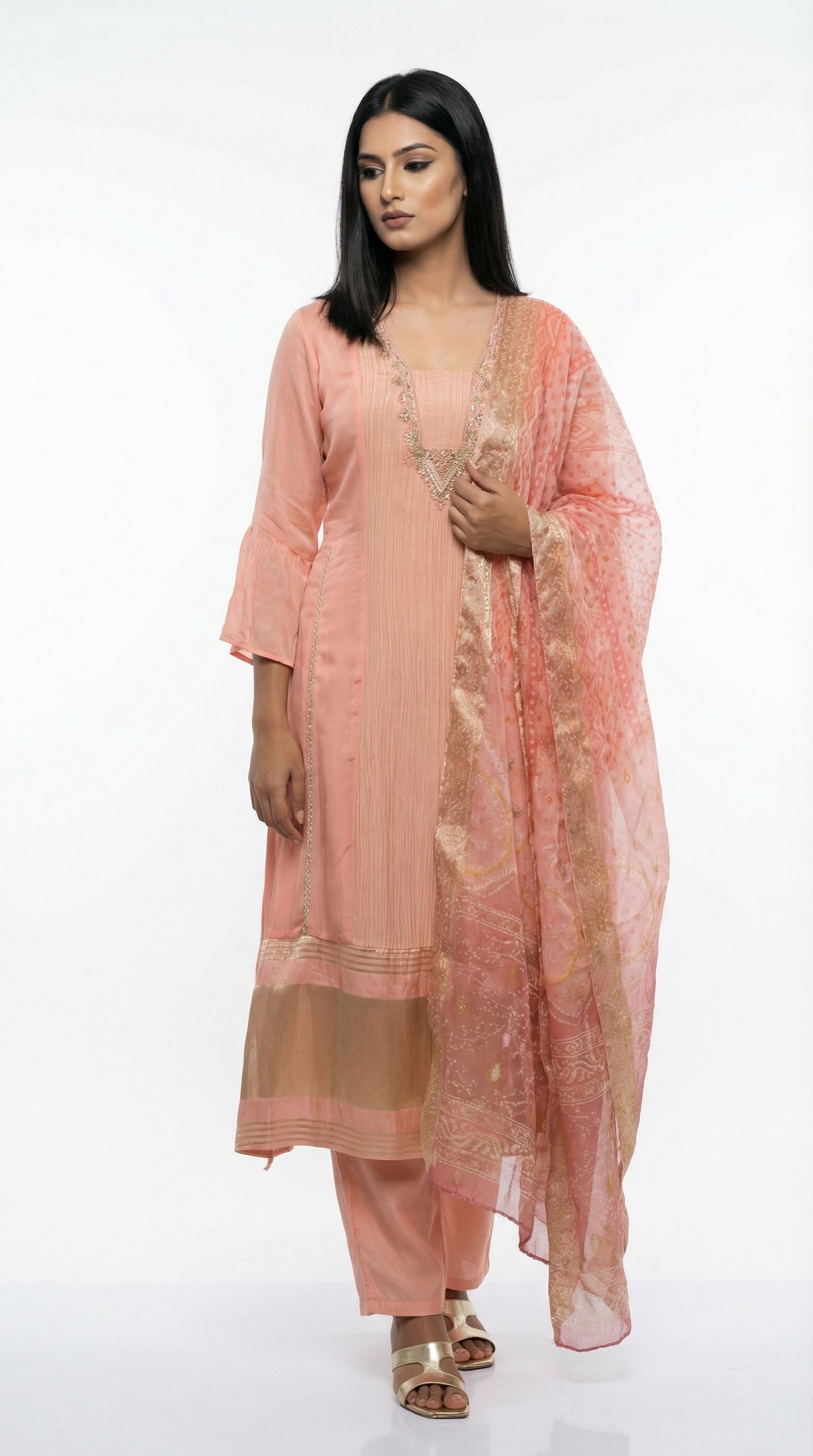 A view of the sheer peach organza dupatta showing the subtle gold foil print and shimmering texture.