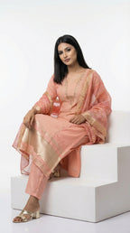 Close-up detail of the trendy bell sleeves and the textured center panel with gold trim on the peach kurta.