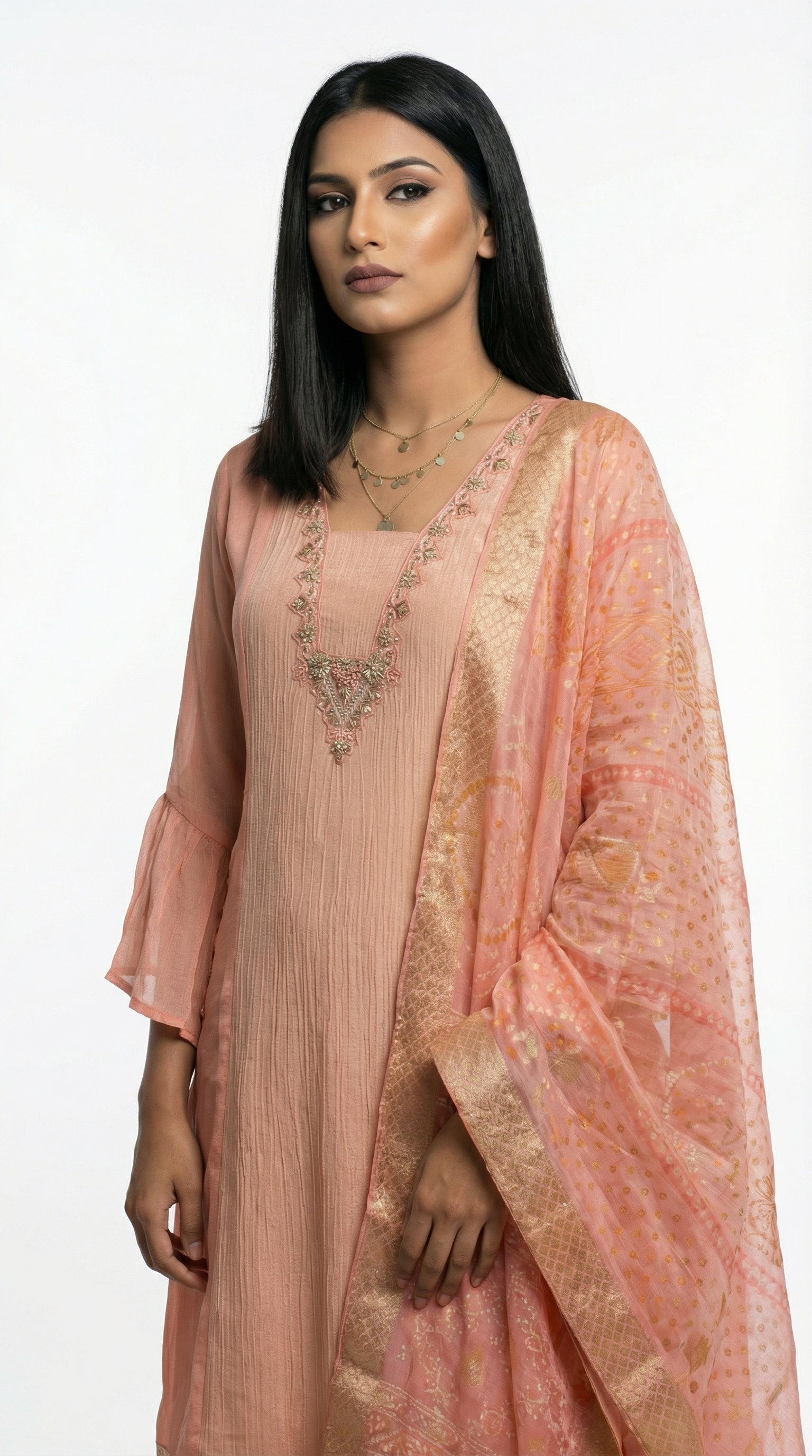 A stylish pose showing the complete pastel peach suit look, perfect for a sophisticated day event or office celebration.