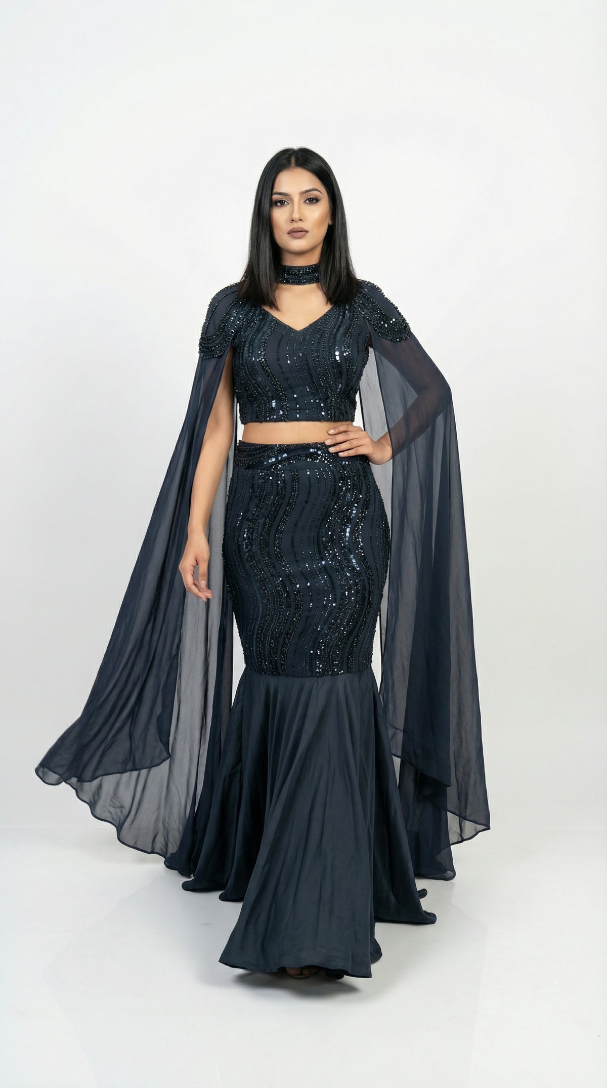 Full body front view of the Rosio House navy blue fish cut lehenga featuring a sequin mermaid skirt and floor-length cape sleeves.