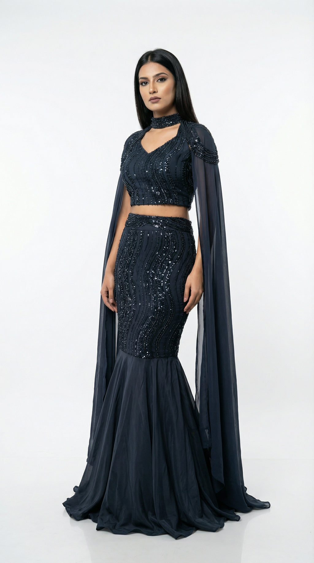 Detail of the fitted mermaid skirt showing the wave-patterned sequin embroidery and the flared hem.
