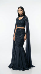 Detail of the fitted mermaid skirt showing the wave-patterned sequin embroidery and the flared hem.