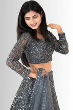 Close-up of the intricate sequin and thread embroidery on the full-sleeve georgette choli of a grey lehenga set