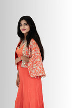 Woman wearing an orange traditional indo western with a floral jacket on a white background