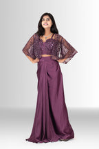 Model wearing the two-piece wine draped skirt and sequin bustier set without the cape, showing a versatile party look.