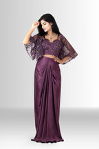 Model wearing the two-piece wine draped skirt and sequin bustier set without the cape, showing a versatile party look.